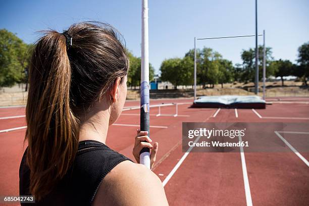 female pole vaulter preparing - stabhochsprung stock-fotos und bilder