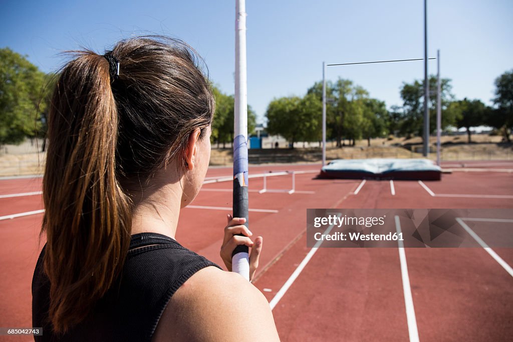 Female pole vaulter preparing