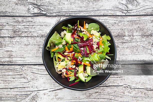 bowl of autumnal salad with lettuce, carrots, avocado, beetroot, pumpkin and sunflower seeds, pomegranate and quinoa - salat stock-fotos und bilder