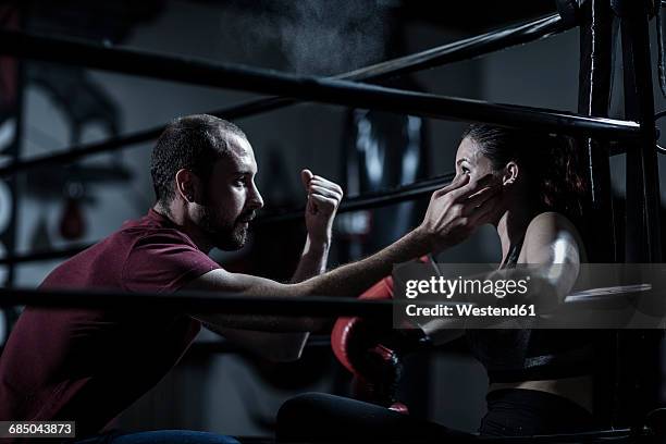 coach with female boxer in boxing ring - boxing media workouts fotografías e imágenes de stock