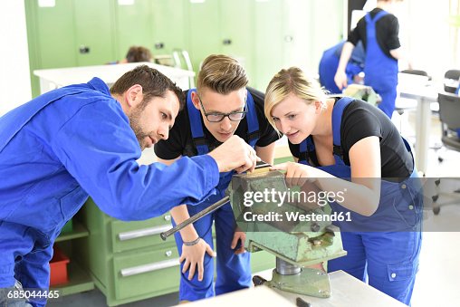 Instructor with trainees at workbench Instructor with trainees at workbench