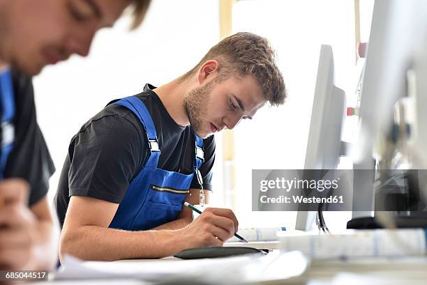 vocational school students writing a test - germany training stock pictures, royalty-free photos & images