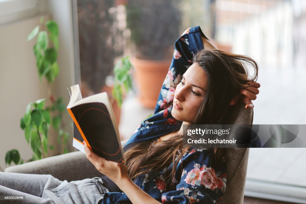 Young woman reading at home