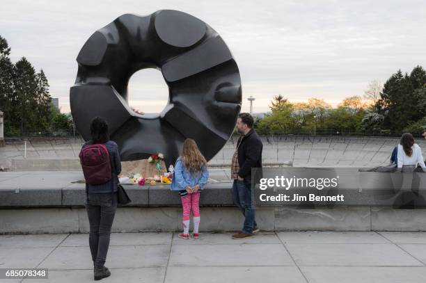 Fans gather at an impromptu memorial created at the Black Sun sculpture in Volunteer Park to honor Chris Cornell on May 18, 2017 in Seattle,...