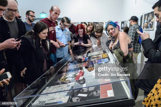 Fans read DJ comments written on vinyl records on display at a memorial for Chris Cornell held at radio station KEXP on May 18, 2017 in Seattle,...