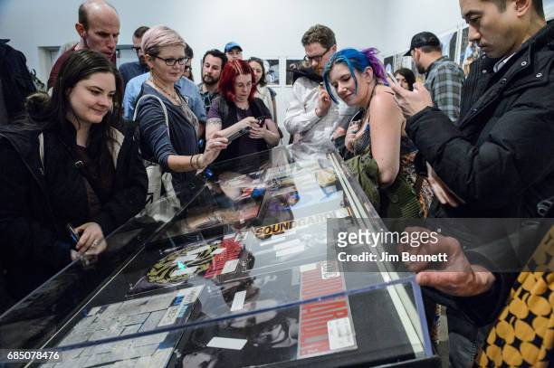 Fans read DJ comments written on vinyl records on display at a memorial for Chris Cornell held at radio station KEXP on May 18, 2017 in Seattle,...