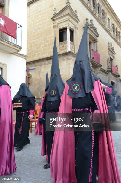 Hooded penitents of the brotherhood of Our Lord in the column, during the general procession on Good Friday in the town of Ubeda, Jaen, Andalusia,...