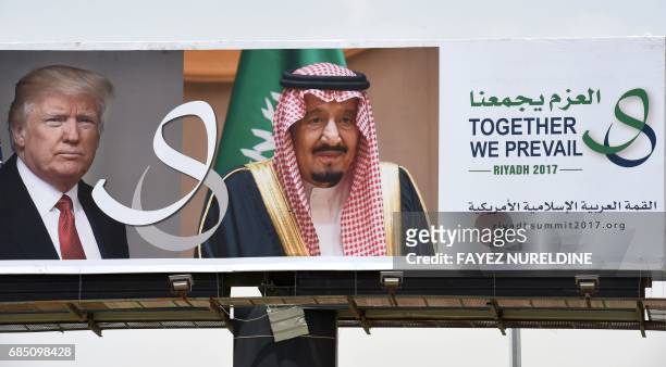 Giant billboard bearing portraits of US President Donald Trump and Saudi Arabia's King Salman, is seen on a main road in Riyadh, on May 19, 2017....