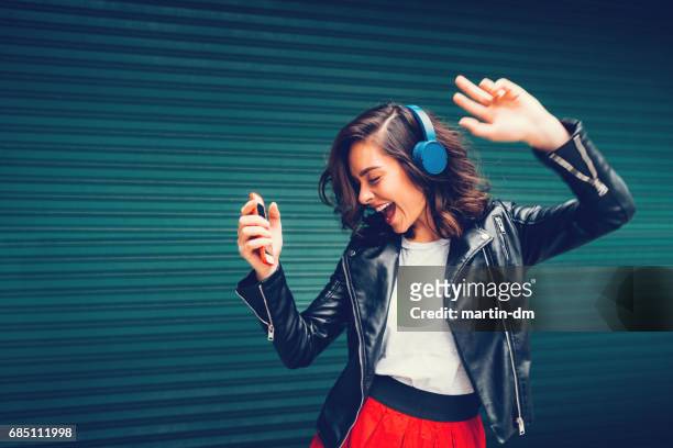 young girl dancing to the music - listening imagens e fotografias de stock