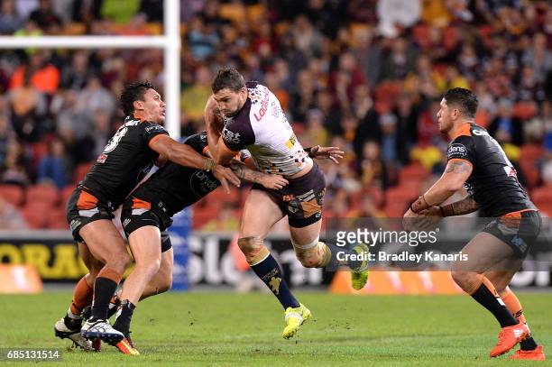 Corey Oates of the Broncos takes on the defence during the round 11 NRL match between the Brisbane Broncos and the Wests Tigers at Suncorp Stadium on...