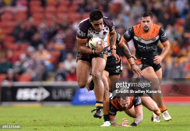 Joe Ofahengaue of the Broncos breaks through the defence during the round 11 NRL match between the Brisbane Broncos and the Wests Tigers at Suncorp...