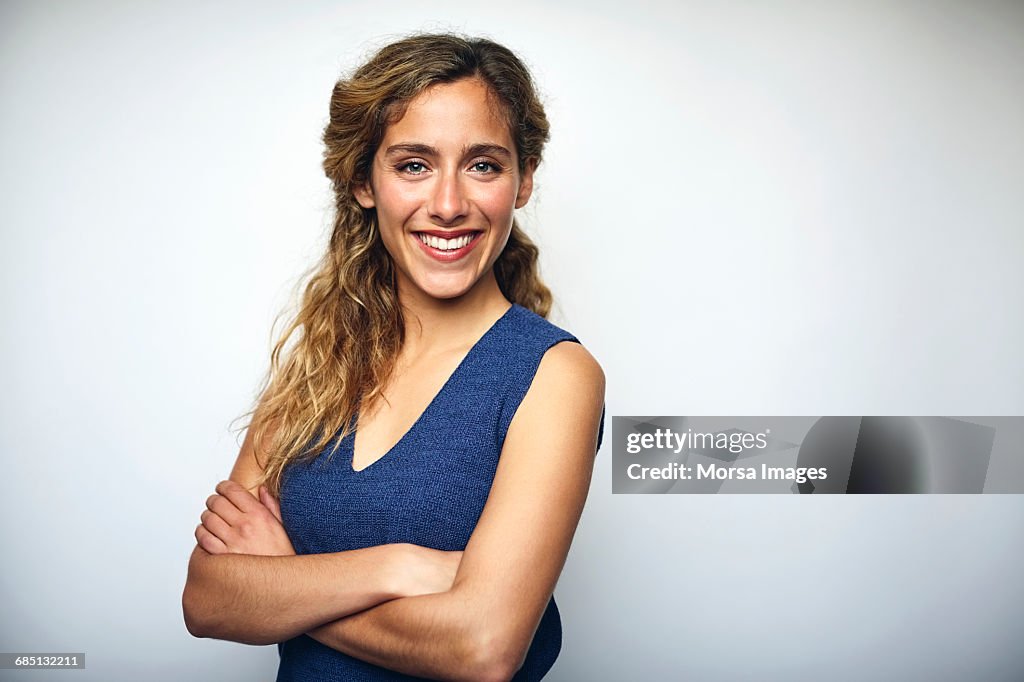 Businesswoman with arms crossed over white