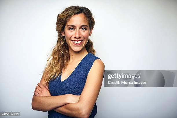 businesswoman with arms crossed over white - young people looking at camera fotografías e imágenes de stock