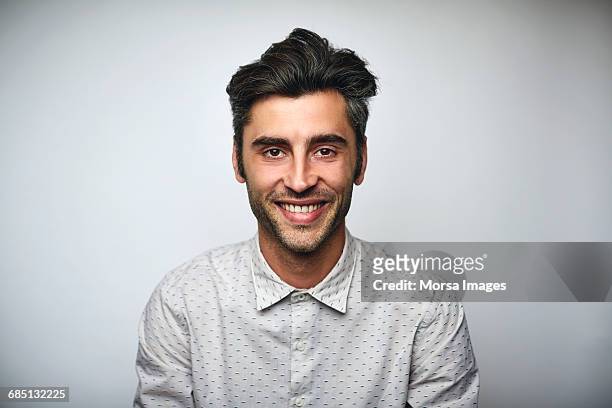male professional smiling over white background - 30 34 años fotografías e im�ágenes de stock