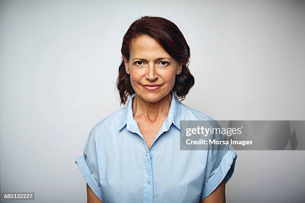 confident businesswoman smiling over white - studio series stock-fotos und bilder