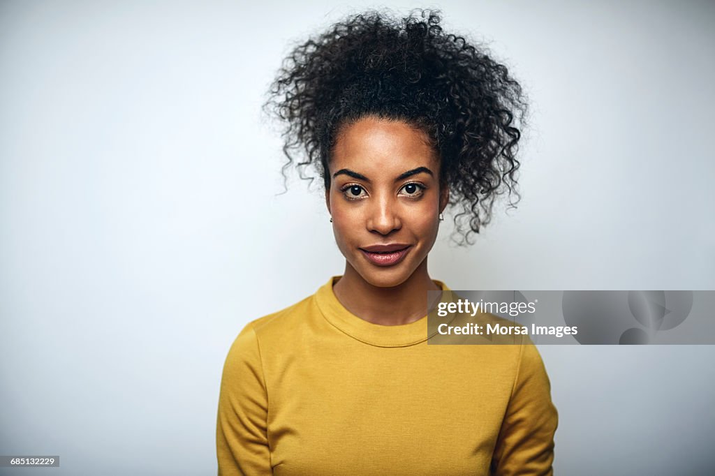 Businesswoman with curly hair over white