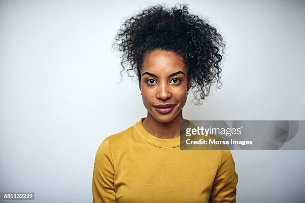 businesswoman with curly hair over white - yellow business stock pictures, royalty-free photos & images