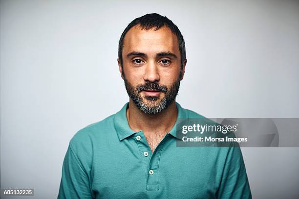 mature businessman over white background - camisa de polo and hombre adulto fotografías e imágenes de stock
