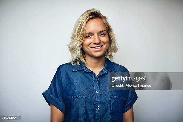 pretty businesswoman smiling over white background - blonde hair brown eyes stock pictures, royalty-free photos & images