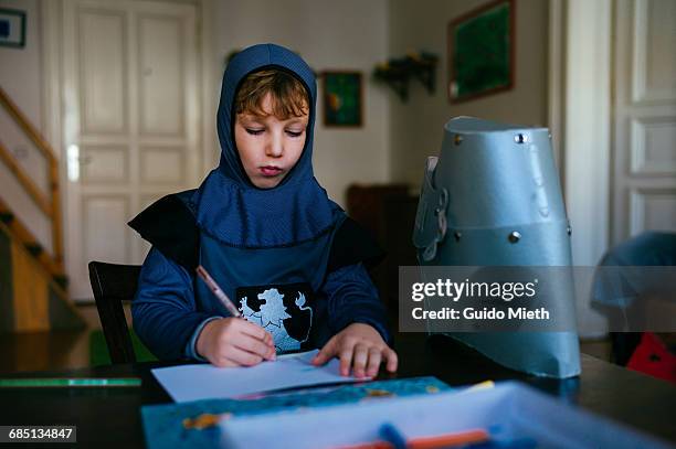 young boy drawing. - ritter stock-fotos und bilder