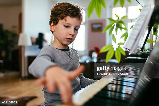 boy playing piano. - kids hobbies stock pictures, royalty-free photos & images