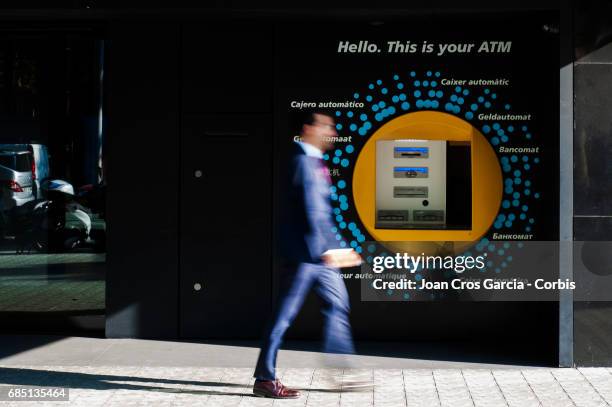 Man walking by a Caixa Bank office, on May 17, 2017 in Barcelona, Spain. "n"n