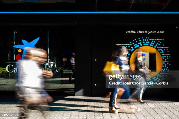 People walking by a Caixa Bank office, on May 17, 2017 in Barcelona, Spain. "n"n