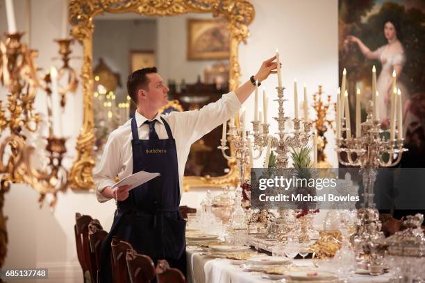 Sotheby's technician adjusts a candelabra on display as part of the Ballyedmond Collection at Sotheby's on May 19, 2017 in London, England.