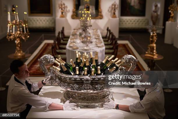 Sotheby's technicians position a silver wine cistern weighing over 70kg, holding bottles of champagne as part of the Ballyedmond Collection at...