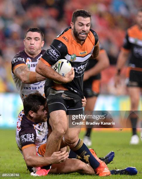 James Tedesco of the Tigers attempts to break away from the defence during the round 11 NRL match between the Brisbane Broncos and the Wests Tigers...