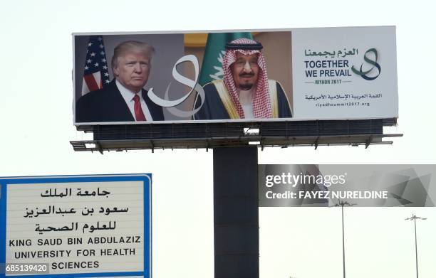 Giant billboard bearing portraits of US President Donald Trump and Saudi Arabia's King Salman, is seen on a main road in Riyadh, on May 19, 2017....