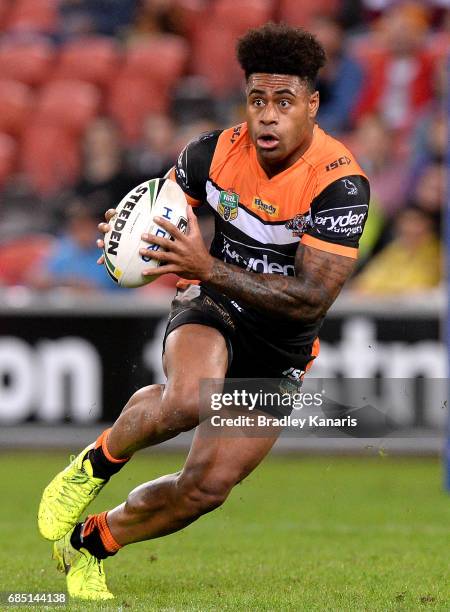 Kevin Naiqama of the Tigers runs with the ball during the round 11 NRL match between the Brisbane Broncos and the Wests Tigers at Suncorp Stadium on...