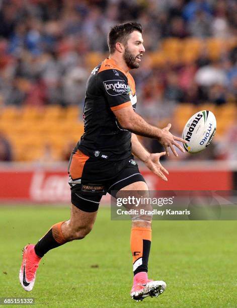 James Tedesco of the Tigers passes the ball during the round 11 NRL match between the Brisbane Broncos and the Wests Tigers at Suncorp Stadium on May...