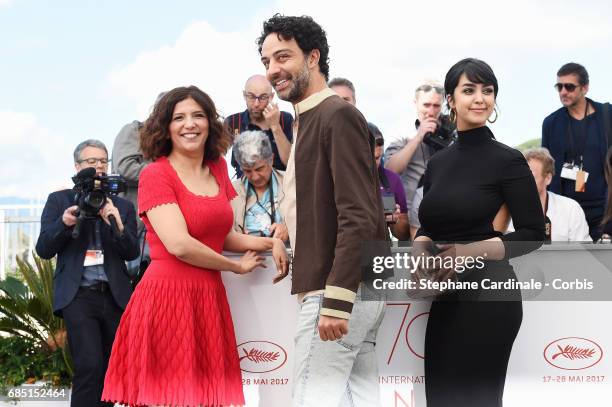 Actors Mariam Al Ferjani, Ghanem Zrelli and director Kaouther Ben Hania attend "Alaka Kaf Ifrit " Photocall during the 70th annual Cannes Film...