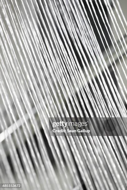 Strands of fibre glass lead into a test loom for advanced industrial weaving at the Open Hybrid Lab Factory on May 19, 2017 in Wolfsburg, Germany....