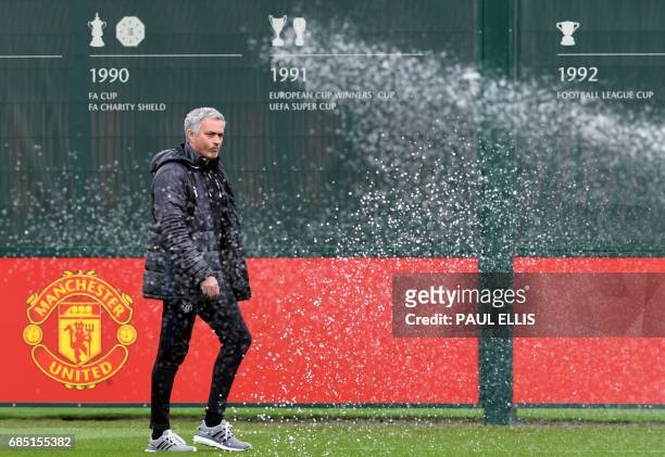 Manchester United's Portuguese manager Jose Mourinho attends a team training session as part of a media open day at the club's training complex near...