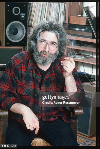 Jerry Garcia, guitarist and singer for the rock band Grateful Dead, smokes a joint during a photo shoot at his home.