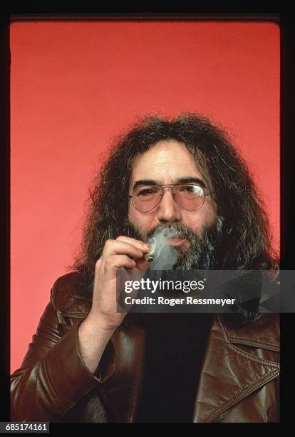 Jerry Garcia, guitarist and singer for the rock group the Grateful Dead, smokes a marijuana cigarette.
