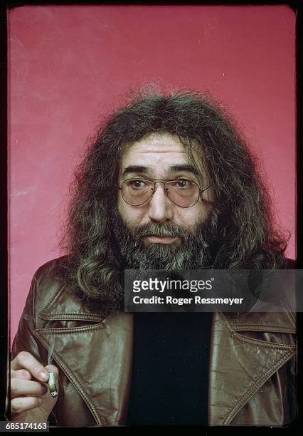 Jerry Garcia, guitarist and singer for the rock group the Grateful Dead, smokes a marijuana cigarette.