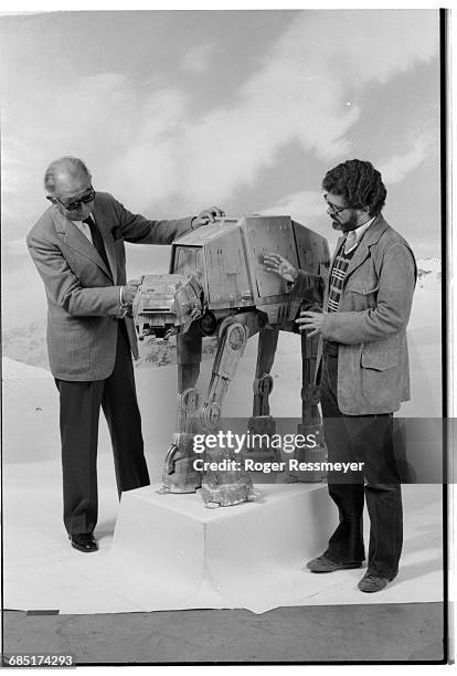 Kurosawa and Lucas look at a model of the "Walker," on a set used for the 1980 film The Empire Strikes Back.