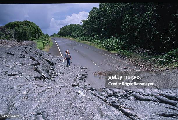 James Moulds walks across lava flows to get to his buried property in Kalapana.