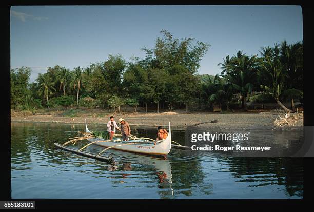 Men in boats patrol the shore of Volcano Island, during an evacuation. Philippines.
