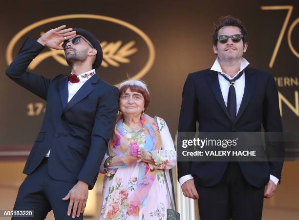 French artist and photographer JR , French director Agnes Varda and French singer/composer Matthieu Chedid a.k.a M pose as they arrive on May 19,...