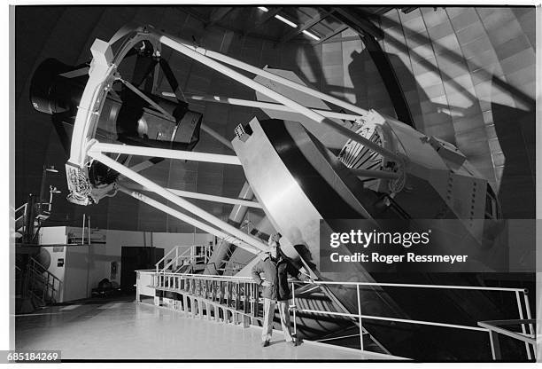 Donald McCarthy stands next to the Mayall Telescope at the Kitt Peak Observatory near Tucson, Arizona. | Location: near Tucson, Arizona, USA.