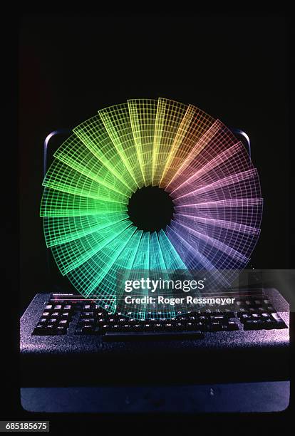 Color highlights a spinning compressor blade superimposed over the keyboard of a Cray Supercomputer. The Cray is used to test the blades, which are...