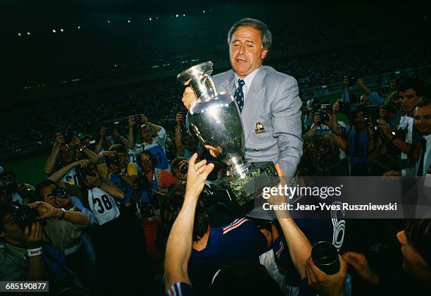 France's coach Michel Hidalgo, holding the trophy, is carried by French players after winning the Euro 1984. In the final France won 2-0 over Spain.