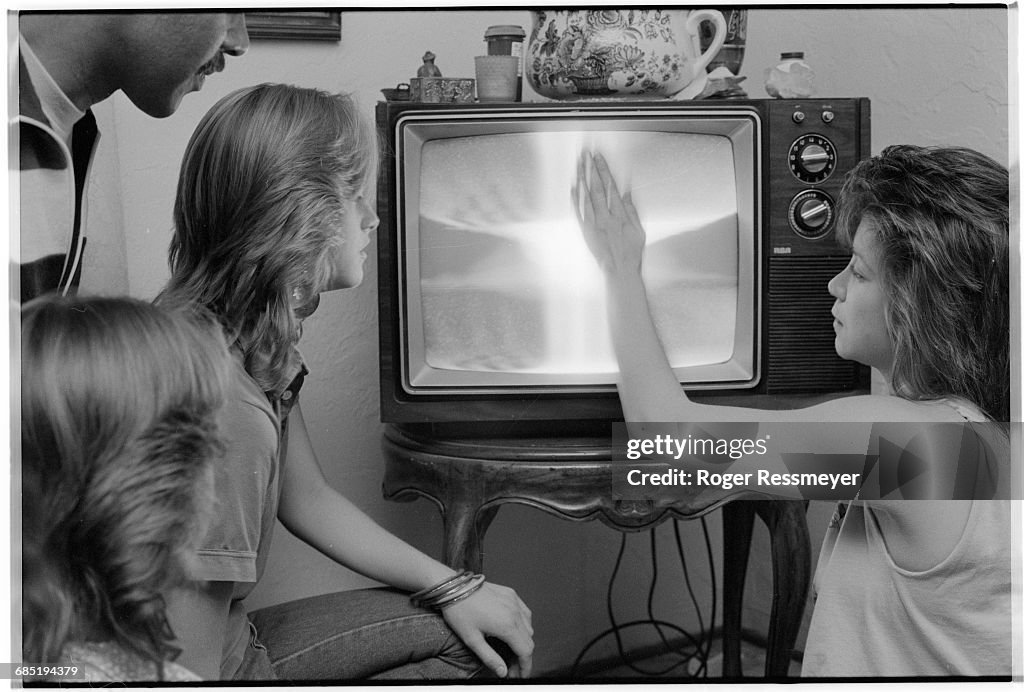 Woman Touching "Angel" in Television Screen