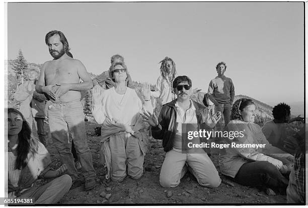 People gathered at Mount Shasta to celebrate the Harmonic Convergence of the planets face the sunset. Some make a spiritual connection through...