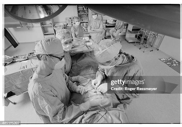 Dr. Burt Brent gives a patient an artificial ear made out of cartilage taken from the patient's rib.
