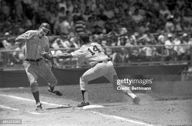 Pulled off the bag by a wide throw, Chris Chambliss, Cleveland first baseman, tags Al Yates of Milwaukee. Indians won, 11-0.